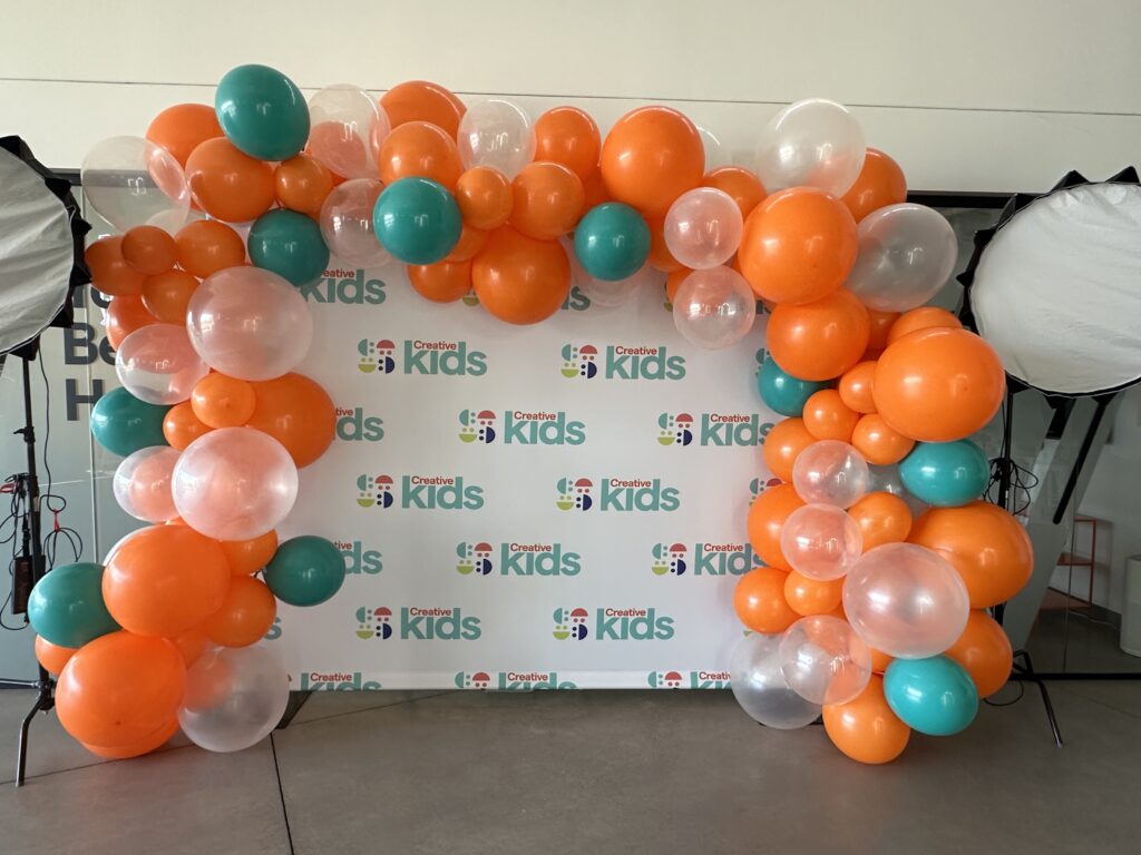 Orange Clear and Teal Garland on Backdrop